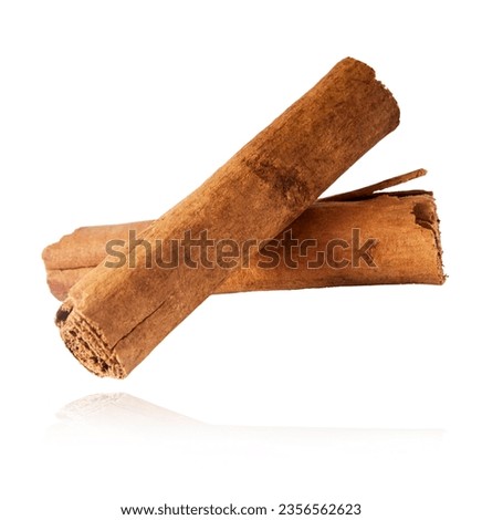 Fresh dried raw Cinnamon stick falling in the air isolated on white backround. Food spices levitation or zero gravity conception. High resolution image. Royalty-Free Stock Photo #2356562623