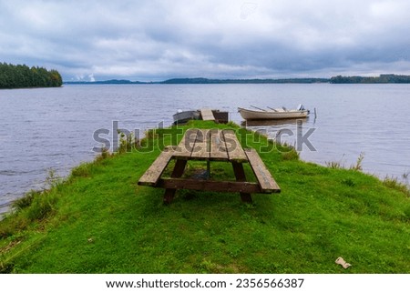 View of the lake with picnic table and boat
