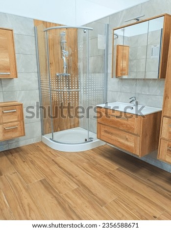 Spacious bathroom in brown tones with heated floors walk-in shower, sink vanity. Royalty-Free Stock Photo #2356588671