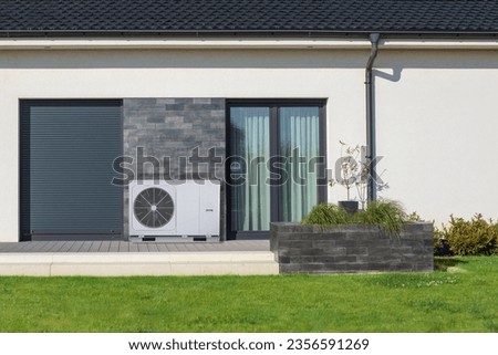 Eco-Friendly Air Heat Pump: Modern Home's Green Solution Royalty-Free Stock Photo #2356591269