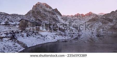 Mountain Hut close to mountains peaks and a frozen lake in the Vallée des merveilles in the south of France. Part of the Parc du Mercantour