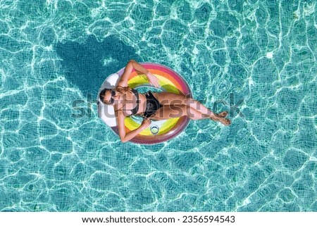 Beauty with inflatable swimming ring inside pool - 0077