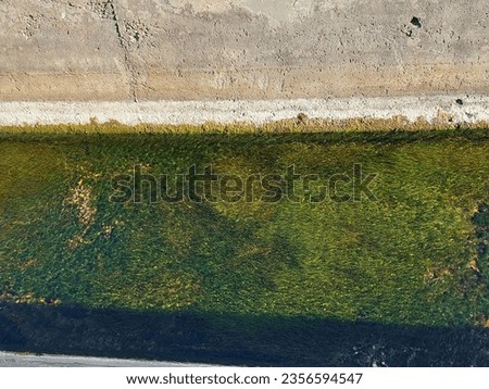 Canal with water with concrete walls, summer, mediterranean.