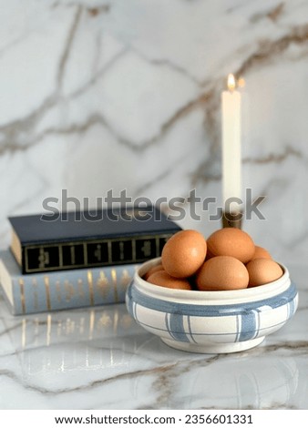 Vertical kitchen picture of eggs and books.