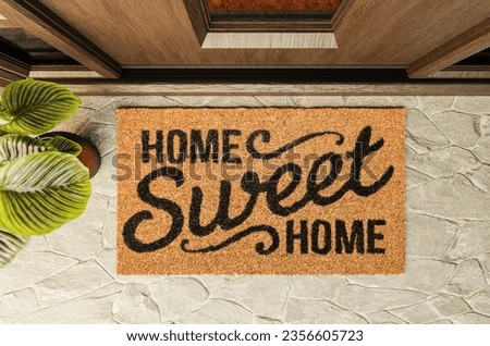 Home Sweet Home doormat on the porch at the front door. Royalty-Free Stock Photo #2356605723