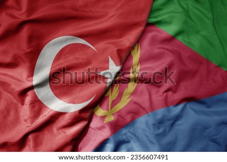 big waving national colorful flag of turkey and national flag of eritrea . macro