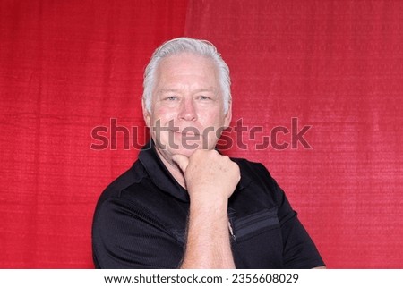 Photo Booth. A man Smiles and Poses while having his Picture Taken in a Photo Booth at a Wedding or Party. People world wide love a fun Photo Booth at Parties and Events. Picture Booth. Smile. Party.