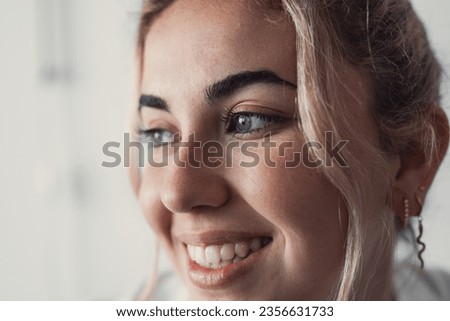 Cropped close up part of female face, happy young Caucasian woman portrait look aside, having white-toothed smile, wrinkles around eyes, staring into distance. Natural beauty, skincare treatments ad Royalty-Free Stock Photo #2356631733