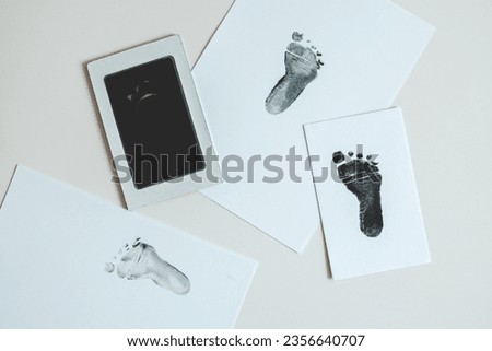 Baby footprints on white paper. Top view.