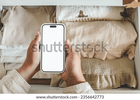 Phone with an isolated screen on the background of children's things, online store.