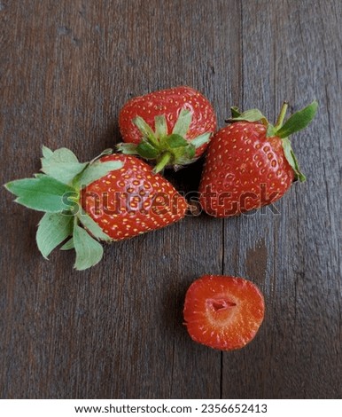 some strawberries on a wooden background