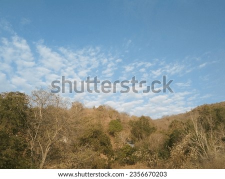 Tranquil landscape: beautiful blue sky with clouds above mountain in the evening