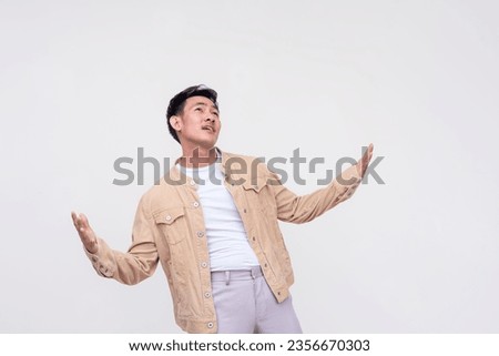An overzealous young man looking up and proclaiming his love. Isolated on a white background. Royalty-Free Stock Photo #2356670303