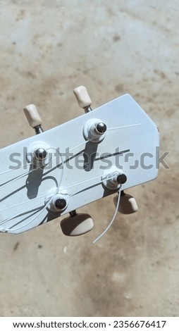 white ukulele with 4 strings
