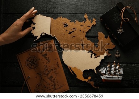 Columbus Day. A wooden model of America with a notebook and a ship