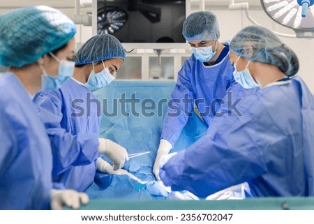 Doctor and assistant nurse operating for help patient from dangerous emergency case .Surgical instruments on the sterile table in the emergency operation room in the hospital.Health care and Medical Royalty-Free Stock Photo #2356702047