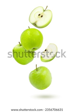 Green granny smith apples flying in the air isolated on white background.