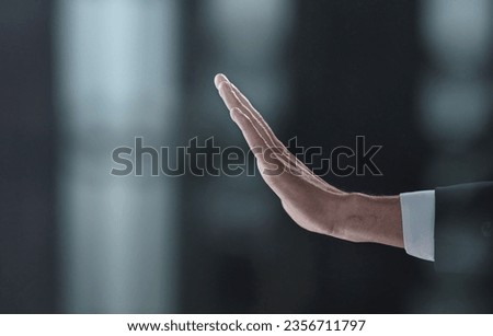 Man making stop sign with his hand at black background