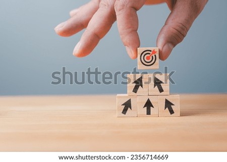 wooden blocks stacked on table with black arrow icon concept to 