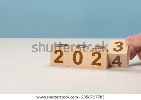 happy new year concept, Flipping of wooden cube block change from 2023 to 2024. Wooden cube with flip over block 2023 to 2024 word. Business management, Inspiration to success ideas and goals. Royalty-Free Stock Photo #2356717785