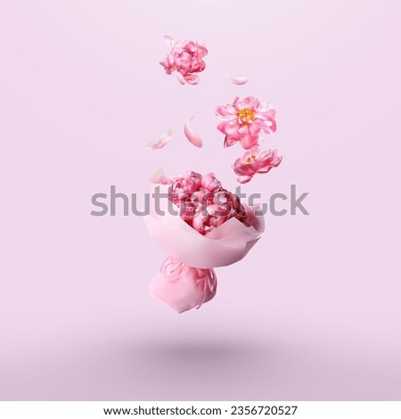 Peony flowers falling into beautiful bouquet on pink background