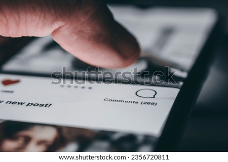Young man using smart phone, Social media concept. All the graphics on the screen are made up. Royalty-Free Stock Photo #2356720811