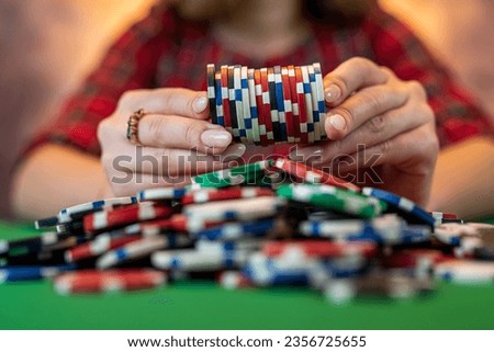 hands of a young Caucasian woman with a beautiful manicure at the casino table close-up. poker game concept