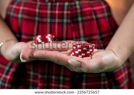 girl shows in front of her a colored poker red chip in her hands. Poker. casino. isolated on plain background