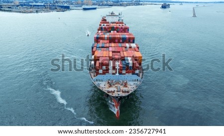 Aerial side view of cargo container ship carrying container from custom container depot go to ocean concept freight shipping by ship service on blue sky .Freight Forwarding Service