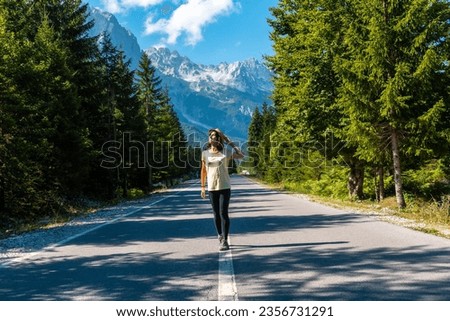 Young tourist walking on the road in Valbona valley, Theth national park, Albanian Alps, Valbona Albania