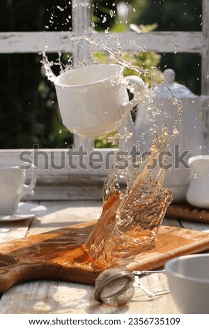 stilllife photography, the glass flies and spills, releasing the contents inside
