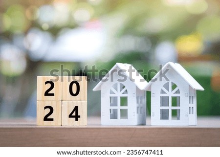 2024 Happy New Year background. Plan and manage for new home, new year budget, tax, loan, real estate, property investment, Business and financial concept. Two house and 2024 wooden blocks number. 