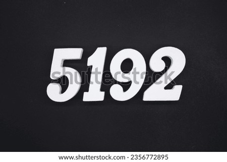 Black for the background. The number 5192 is made of white painted wood.