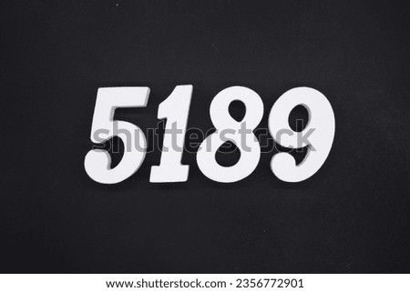 Black for the background. The number 5189 is made of white painted wood.