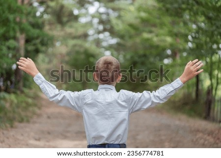 Happy boy with open arms outdoor