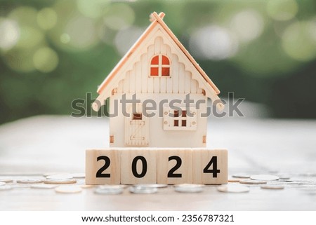 2024 New year. New home, budget, Real estate, Asset management, Business and financial, New year property investment concept. House model on 2024 wooden blocks and coins on floor. Happy new year 2024.