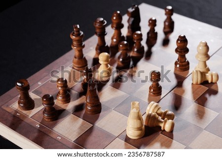 Chess sets in different arrangements on black table