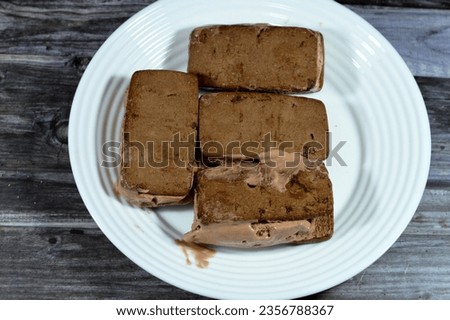 Chocolate sandwich ice cream with cookies, cookie biscuits with chunks of chocolate stuffed with ice cream, summer and holidays concept, summer desserts and refreshments, selective focus