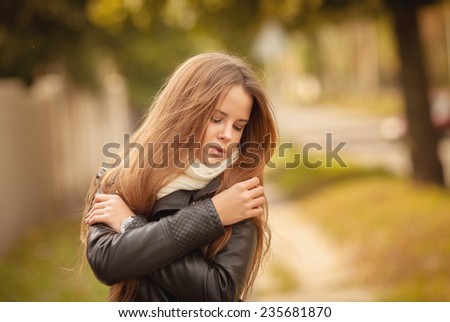 beautiful young blond woman walking outdoors in autumn 