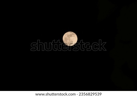Full moon in the dark night sky on summer evening. Negative space