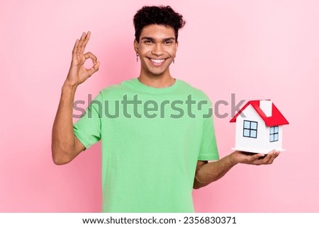 Photo of cheerful satisfied man wear trendy green clothes buy new flat apartment rent room okey sign isolated on pink color background