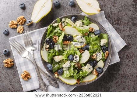 Fresh diet salad with blueberries, lettuce, gorgonzola cheese, walnuts and pear close-up in a plate on the table. horizontal top view from above
 Royalty-Free Stock Photo #2356832021