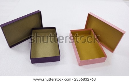 Two pictures of open gift boxes