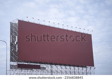 Large blank outdoor billboard with sky background. Promotional information for announcements and marketing details.