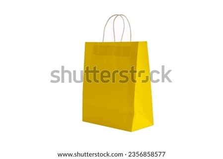 Yellow paper bag laying on a white background.