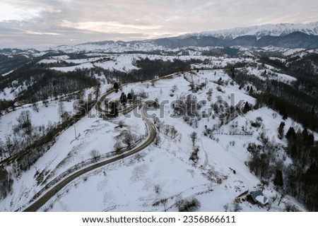 A majestic snow-covered mountain taken from a drone in Moeciu Aerial Drone Moeciu Brasov