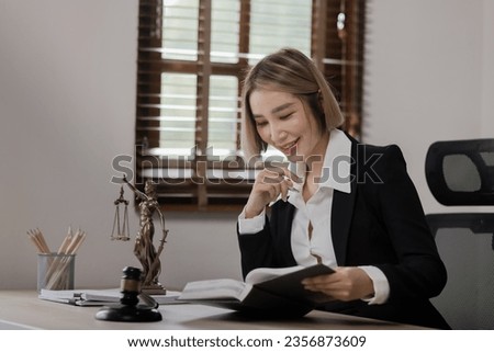 Lawyer contact us concept: Lawyer business woman working with law book sitting in office, justice and law, attorney.