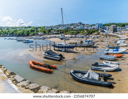 A view from the harbour wall at low tide back towards the town of New Quay, Wales in summertime Royalty-Free Stock Photo #2356874707