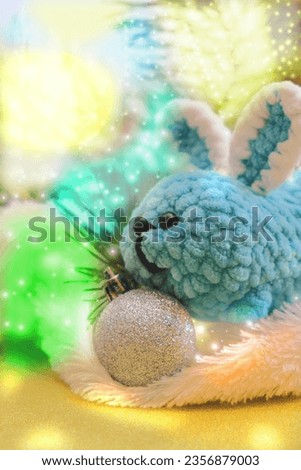 New Year decorations. Christmas card with funny toy bunny with fluffy white plaid . Happy new year