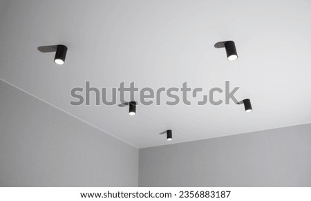 Modern black LED ceiling lights in a room on the ceiling Royalty-Free Stock Photo #2356883187